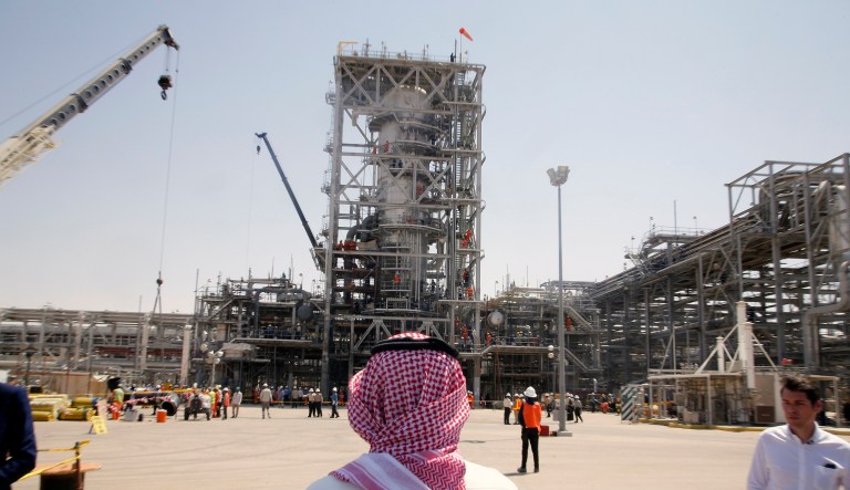 In this photo opportunity during a trip organized by Saudi information ministry, a man stands in front of the Khurais oil field in Khurais, Saudi Arabia, Friday, Sept. 20, 2019, after it was hit during Sept. 14 attack. 