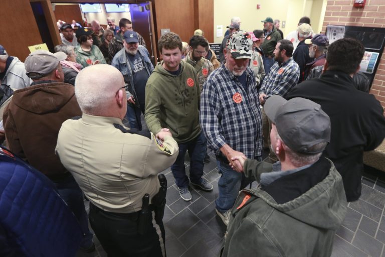 Spectators file out of a packed Buckingham County Board of Supervisors meeting after the board unanimously voted to pass a Second Amendment Sanctuary City resolution in Buckingham , Va. Several county sheriffs are backing the movement.