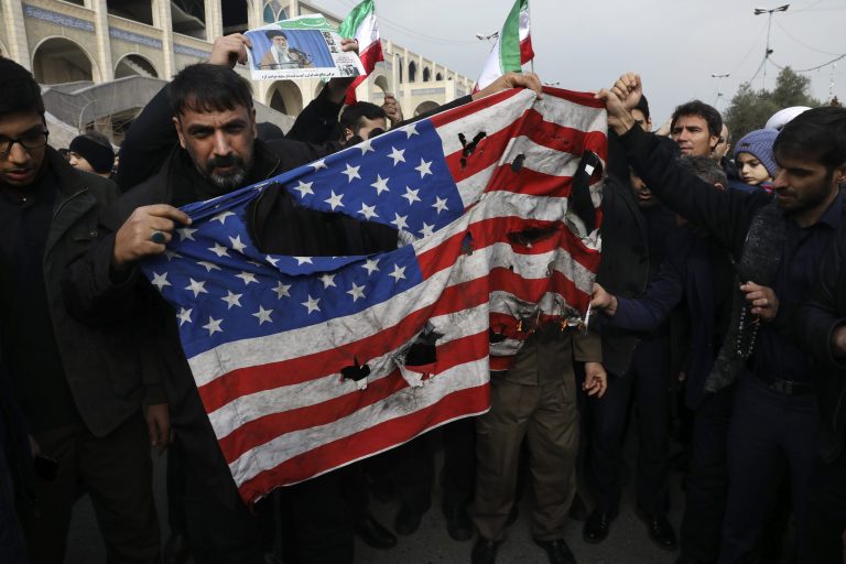 Protesters burn a U.S. flag during a demonstration over the U.S. airstrike in Iraq that killed Iranian Revolutionary Guard Gen. Qassem Soleimani, in Tehran, Iran, Jan. 3, 2020. Iran has vowed "harsh retaliation" for the U.S. airstrike near Baghdad's airport that killed Tehran's top general and the architect of its interventions across the Middle East.