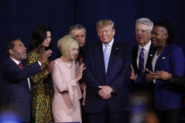 Faith leaders pray with President Donald Trump during a rally for evangelical supporters at the King Jesus International Ministry church, Friday, Jan. 3, 2020, in Miami.