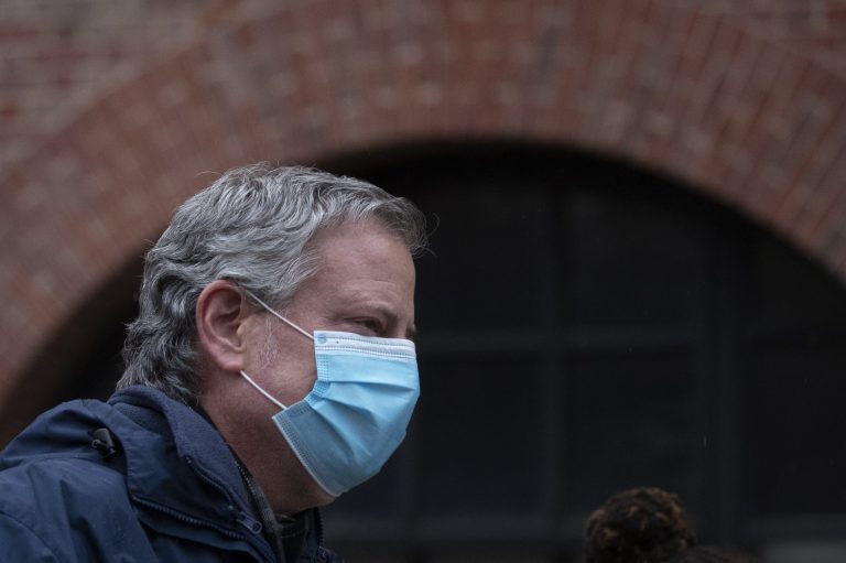Mayor Bill de Blasio wears a mask while honoring healthcare workers at Brooklyn's Kings County Hospital Center during a 7 o'clock ceremony during the coronavirus pandemic, Friday, April 24, 2020, in New York.
