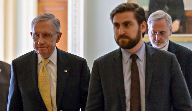 Senate Majority Leader Harry Reid of Nev., leaves the Senate floor on Capitol in Washington, Wednesday, March 5, 2014, after President Barack Obama's choice to head the Justice Department's civil rights division failed a Senate test vote and put the confirmation of Debo Adegbile in jeopardy. His spokesman Adam Jentleson accompanies at right. 
