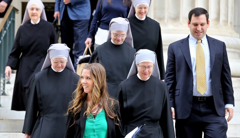 Lead cousel Mark Rienzi, far right, and legal team member Emily Hardman, second from left, both representing Little Sisters of the Poor, walk with members of the Catholic religious institute after attending a hearing in the 10th U.S. Circuit Court of Appeals, in Denver, Colo., in 2014.