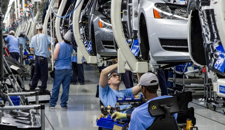 Workers assemble sedans in an automaker's plant. 