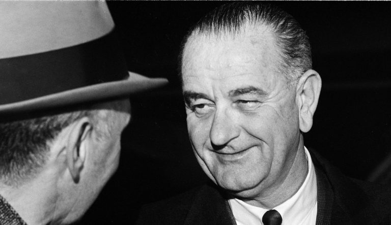 President Lyndon B. Johnson sports a big grin as he arrives at Andrews Air Force Base in Maryland, Jan. 5, 1964. The chief executive returned to Washington after a two-week working holiday at his Texas ranch.  
