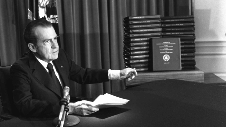 President Nixon gestures toward transcripts of White House tapes after announcing he would turn them over to House impeachment investigators and make them public in April of 1974.