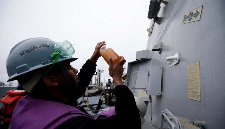 A sailor checks a sample of fuel during a refueling at sea aboard the USS William P. Lawrence guided missile destroyer in waters off  Coronado, Calif.