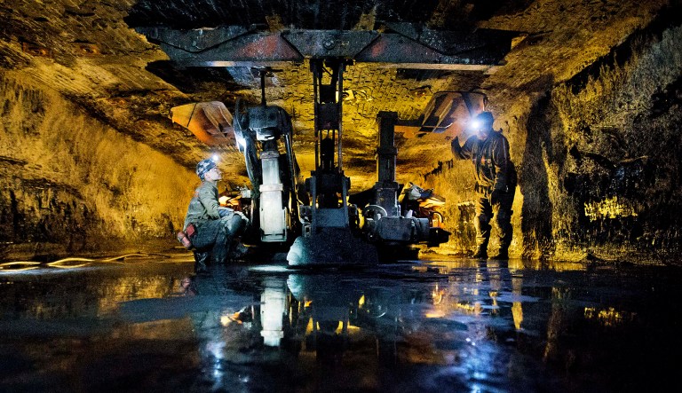 James Phillips (left) and Chad Cordill (right) use a roof bolting machine to secure with roof of the Sewell "R" coal mine in Yukon, W.Va. 