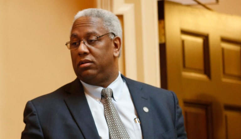 This Wednesday Feb. 25, 2015 photos shows State Sen. Chap Petersen, D-Fairfax, left, talks with Sen. Donald McEachin, D-Richmond, on the floor of the Senate during the session at the Capitol in Richmond, Va.