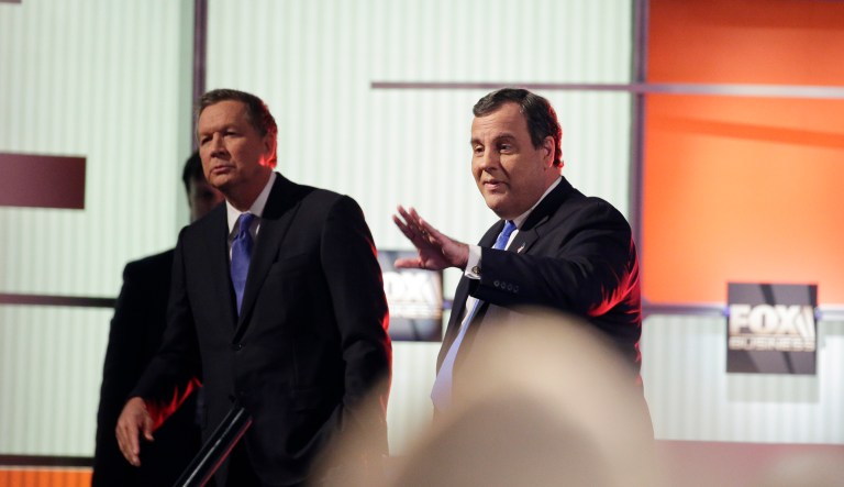 Republican presidential candidate, Ohio Gov. John Kasich, left, and Republican presidential candidate, New Jersey Gov. Chris Christie look to the crowd at a break during the Fox Business Network Republican presidential debate at the North Charleston Coliseum, Thursday, Jan. 14, 2016, in North Charleston, S.C. 