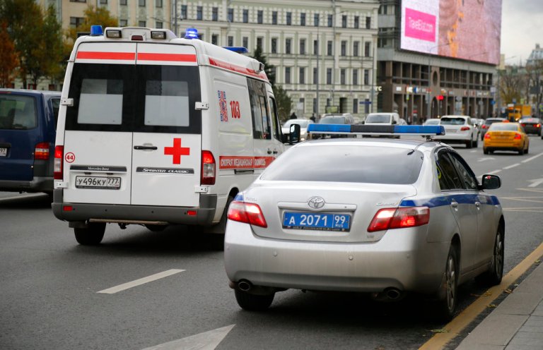 An ambulance passes a police car parked, in front of the Ekho Moskvy (Echo of Moscow) radio station office in Moscow, Russia, Monday, Oct. 23, 2017. Russiaâs leading news radio station said on Monday its deputy editor-in-chief has been stabbed by an unknown attacker.