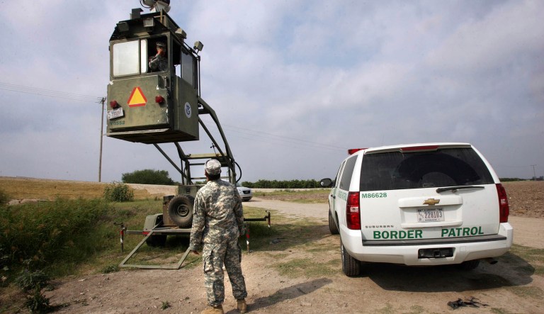 A member of the U.S. National Guard checks on his colleague inside a Border Patrol Skybox in Hidalgo, Texas. 