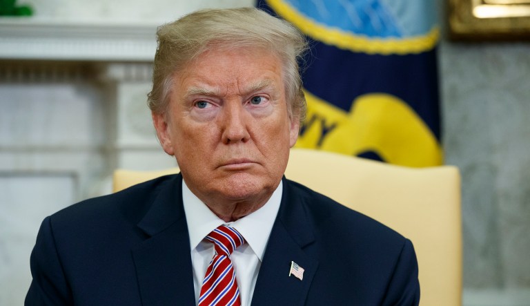 President Trump listens during a meeting in the Oval Office of the White House. 