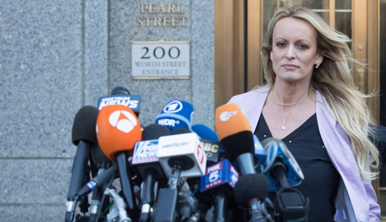 Adult film actress Stormy Daniels approaches the microphones set up outside federal court to address reporters in New York. 