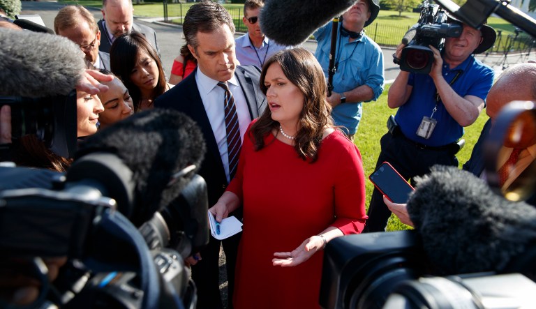 White House press secretary Sarah Sanders talks to reporters outside the White House. 