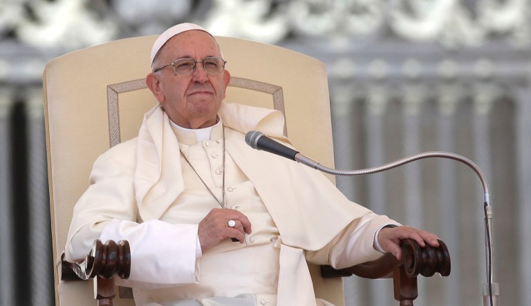 Pope Francis sits during his weekly general audience in St. Peter's Square at the Vatican. 