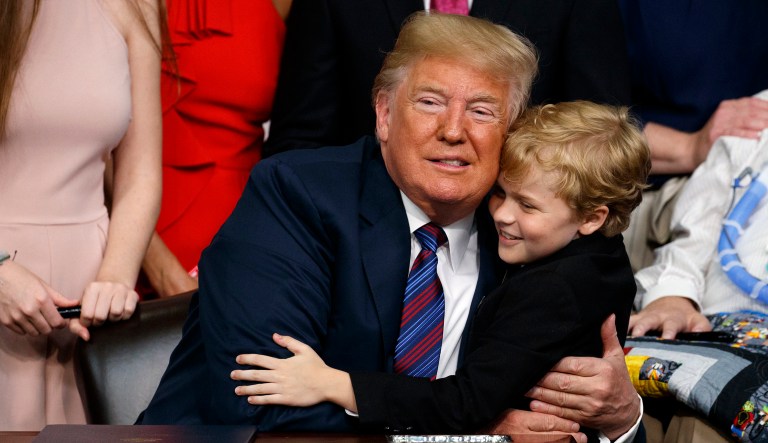 Child repeatedly tries, eventually succeeds in hugging Trump at 'Right To Try' bill signing: Watch