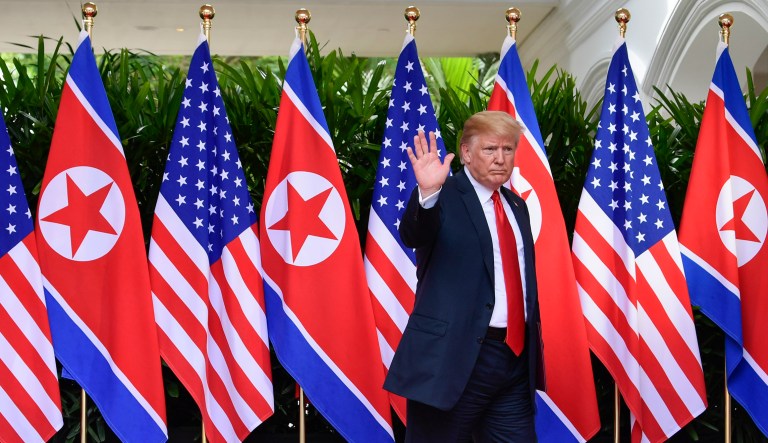 President Trump waves after saying goodbye to North Korea leader Kim Jong Un at the Capella resort on Sentosa Island in Singapore. 