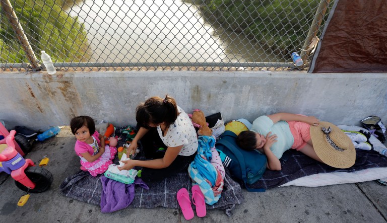 Immigrants from Cuba and Guatemala seeking asylum in the United States wait on the Matamoros International Bridge above the Rio Grande in Matamoros, Mexico.