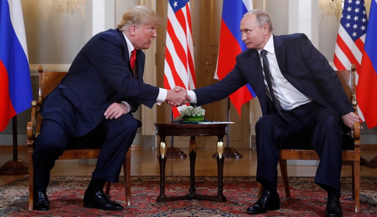 U.S. President Donald Trump, left, and Russian President Vladimir Putin shake hand at the beginning of a meeting at the Presidential Palace in Helsinki, Finland, Monday, July 16, 2018. 