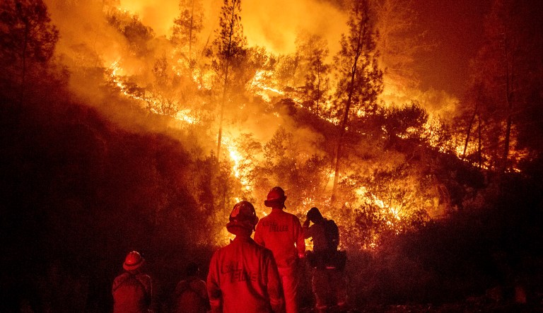 Firefighters monitor a backfire while battling the Ranch Fire, part of the Mendocino Complex Fire near Ladoga, Calif. 