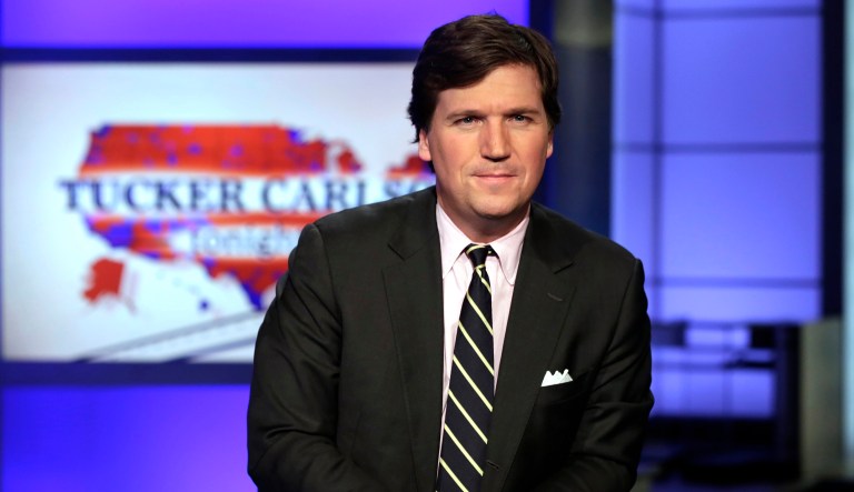 Tucker Carlson, host of "Tucker Carlson Tonight," poses for photos in a Fox News Channel studio, in New York, Thursday, March 2, 2017.