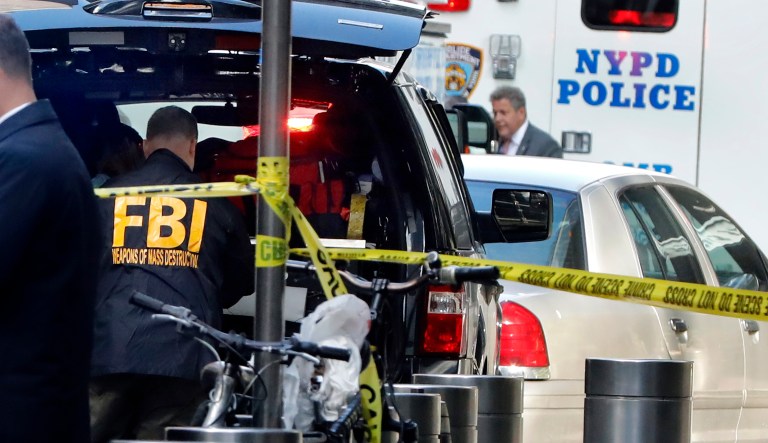 A member of the FBI works outside the Time Warner Center, in New York, Wednesday, Oct. 24, 2018. A police bomb squad was sent to CNN's offices in New York City and the newsroom was evacuated because of a suspicious package.
