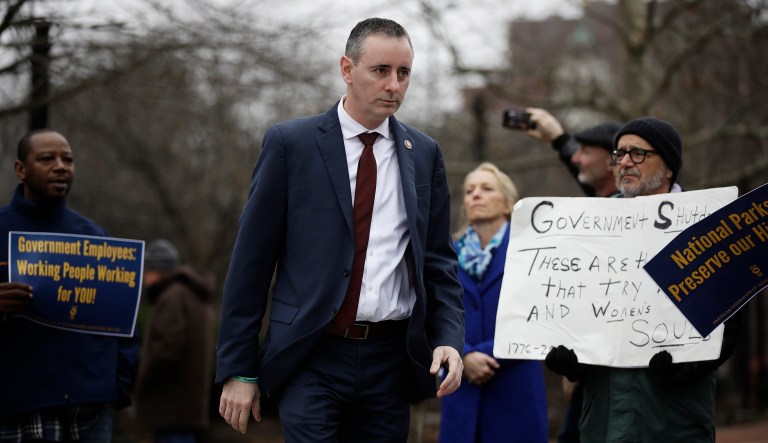 Rep. Brian Fitzpatrick, R-Pa., walks to a podium to speak during a demonstration against the partial government shutdown on Independence Mall in Philadelphia, Tuesday, Jan. 8, 2019.