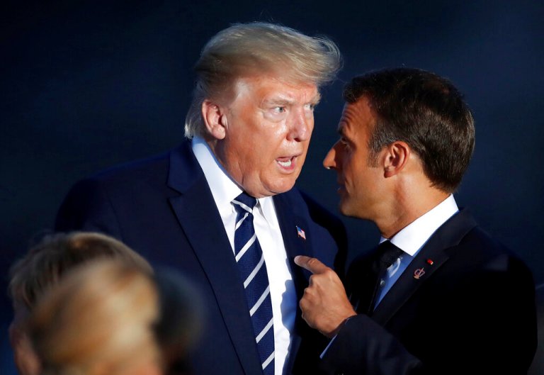 President Donald Trump talks to French President Emmanuel Macron during the G-7 family photo Sunday, Aug. 25, 2019 in Biarritz, France. 