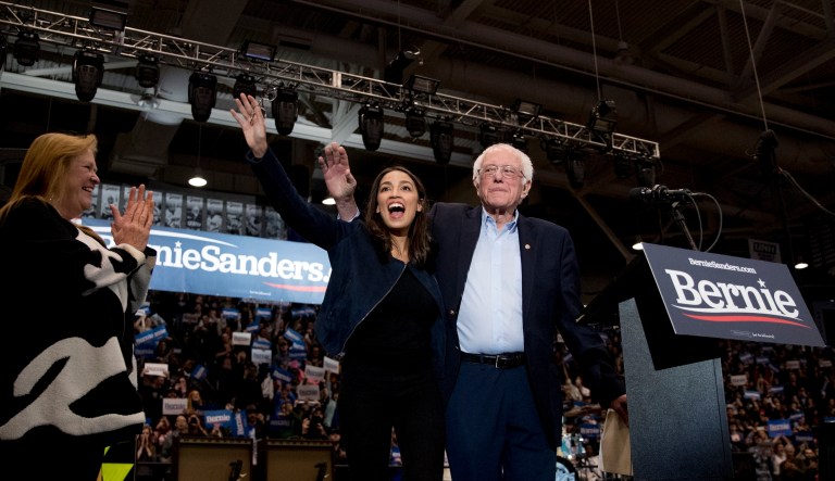 Democratic presidential candidate Sen. Bernie Sanders, I-Vt., accompanied by his wife Jane Sanders, left, and Rep. Alexandria Ocasio-Cortez, D-N.Y. Their Green New Deal could be costly.