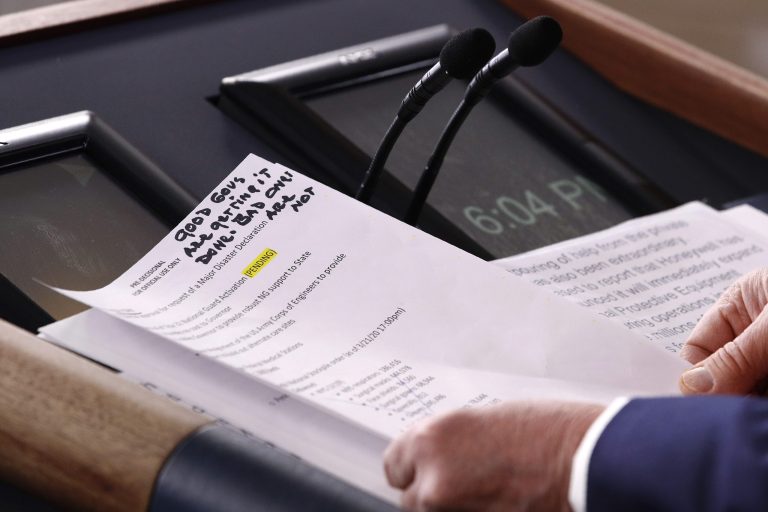 President Donald Trump handles notes as he speaks during a coronavirus task force briefing at the White House, Sunday.