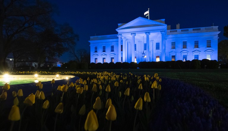The White House is illuminated with blue light to call attention to World Autism Awareness Day, Thursday, April 2, 2020, in Washington.