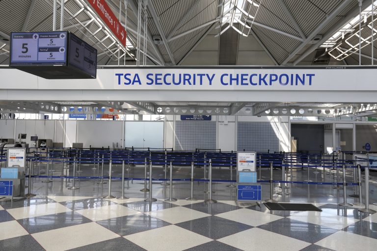 A sign telling passengers it will take only five minutes to get through security hangs above an empty security line at O'Hare International Airport in Chicago on April 16, 2020. The U.S. is offering airlines a $25 billion aid package, but damage to the sector caused by the coronavirus outbreak will be extensive and long-lasting, industry analysts say.