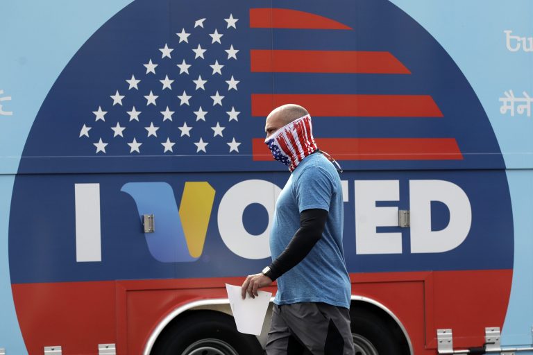 Robb Rehfeld wears a mask as he walks to cast his vote during a special election for California's 25th Congressional District seat Tuesday, May 12, 2020, in Santa Clarita, Calif. Republican Mike Garcia has a big lead over Democrat Christy Smith for the seat that opened after the resignation of Rep. Katie Hill, D-Calif.
