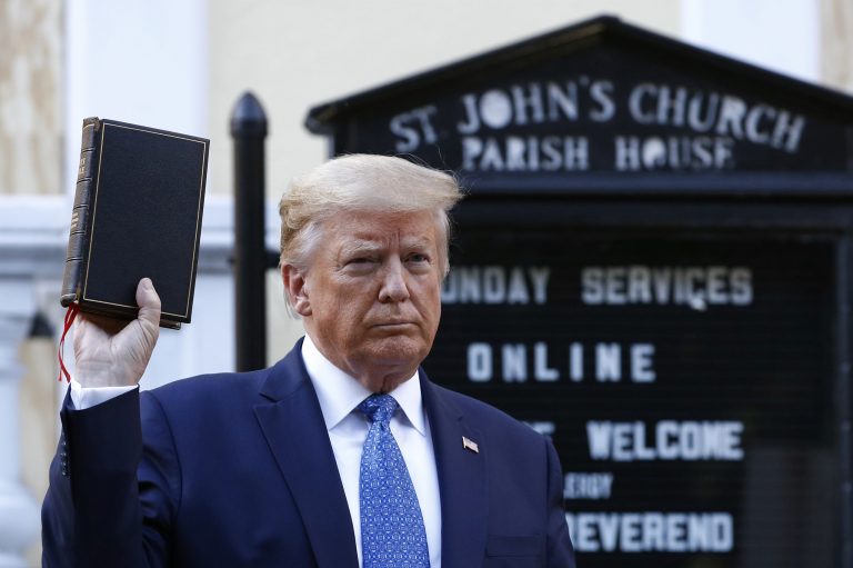 President Donald Trump holds a Bible as he visits outside St. John's Church across Lafayette Park from the White House Monday, June 1, 2020, in Washington. Part of the church was set on fire during protests on Sunday night.