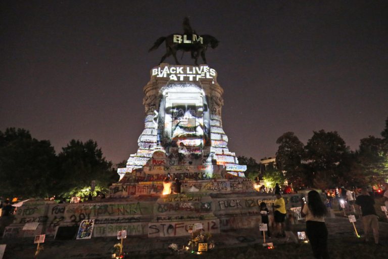 An image of George Floyd is projected on the base of the statue of Confederate General Robert E. Lee on Monument Avenue, Monday, June 8, 2020, in Richmond, Va. The statue has been the focal point of protester over the death of George Floyd.