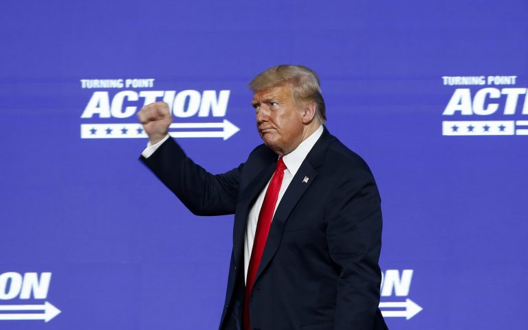 President Donald Trump gives a fist pump to the crowd after speaking at the Students for Trump conference at Dream City Church, Tuesday in Phoenix hosted by Turning Point Action, the political arm of Turning Point USA.