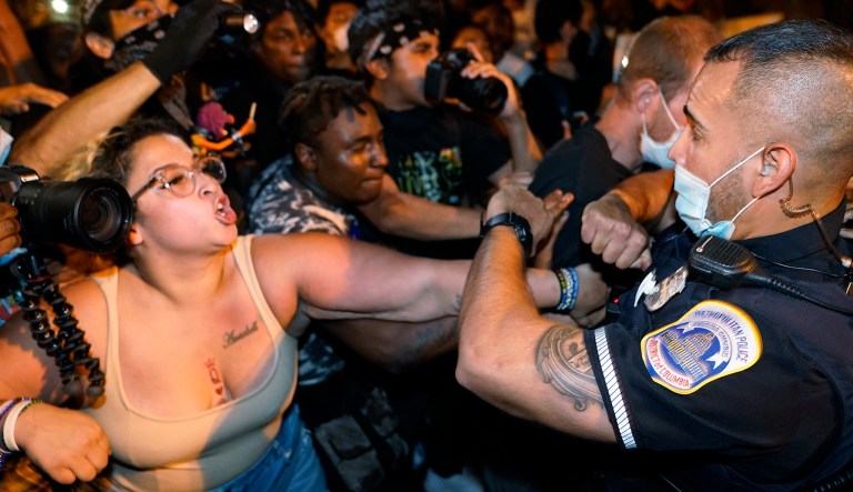 Metropolitan Police are confronted by protestors along a section of 16th Street, Northwest, renamed Black Lives Matter Plaza, Thursday night , Aug. 27, 2020, in Washington, after President Donald Trump had finished delivering his acceptance speech from the White House South Lawn.