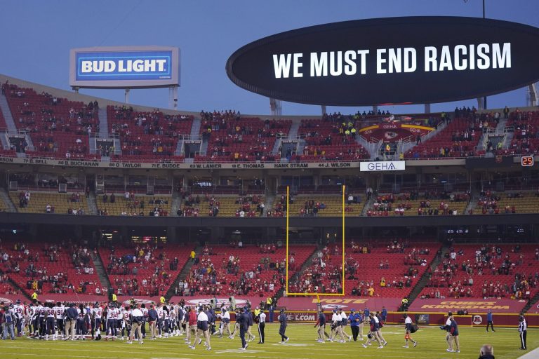 Kansas City Chiefs and Houston Texans players meet on the field during a moment of unity before an NFL football game Thursday, Sept. 10, 2020, in Kansas City, Mo. Some fans booed.