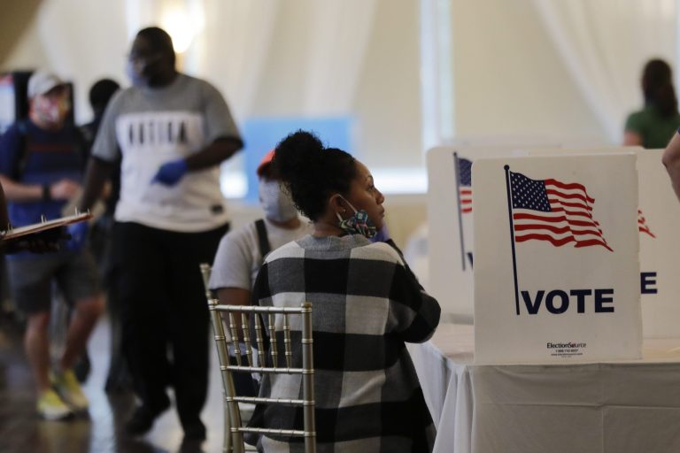 In this June 9, 2020 file photo, people wait to vote in the Georgia's primary election at Park Tavern in Atlanta.  Twice delayed because of the coronavirus pandemic, Georgiaâs primary earlier this year became a poster child for election dysfunction. (AP Photo/Brynn Anderson)