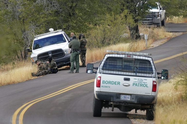A pair of Customs and Border Patrol agents detain three migrants leading up to Montezuma's Pass in Coronado National Memorial, Thursday, Dec. 10, 2020, in Hereford, Ariz. More illegals are surging the border and infecting border agents with the coronavirus.