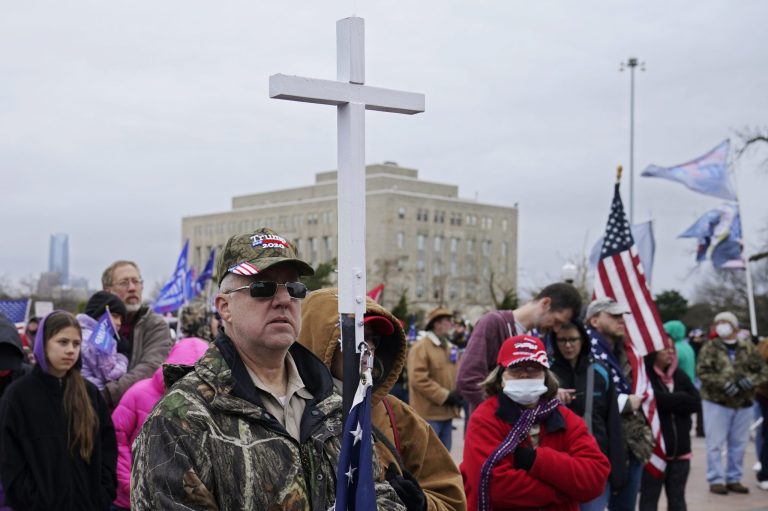 Kenny Womack, of Edmond, Okla., holds a cross at a Trump rally at the state Capitol on January 6 in Oklahoma City.