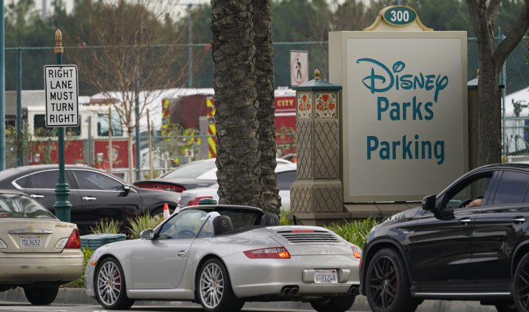 Cars line up outside this Disneyland parking lot located off Katella Avenue on Wednesday, Jan. 13, 2021.