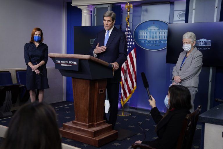 Special Presidential Envoy for Climate John Kerry speaks during a press briefing at the White House, Wednesday, Jan. 27, 2021, in Washington. National Climate Adviser Gina McCarthy, right, and Press Secretary Jen Psaki listen.