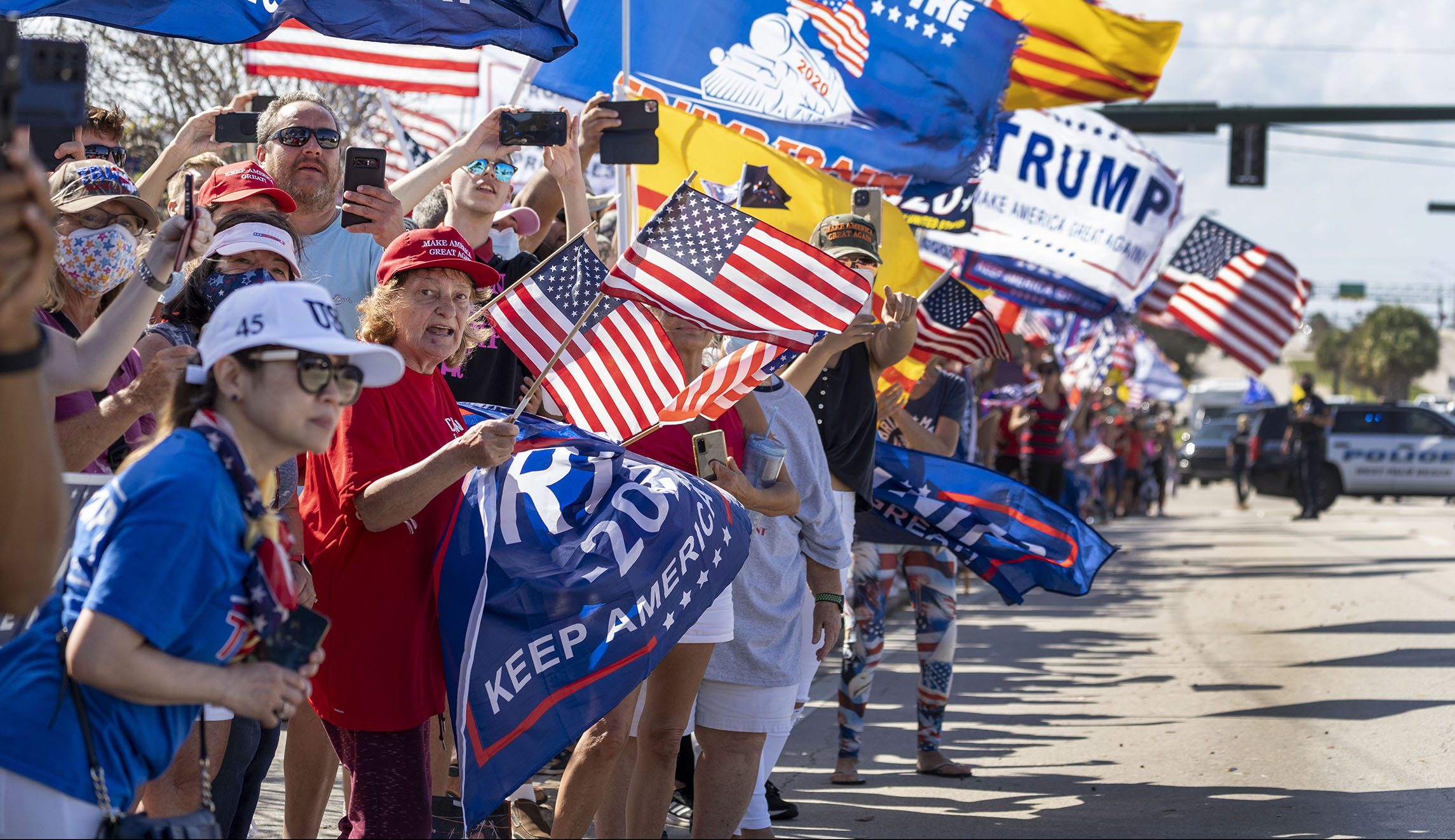 Trump waves to more than 1,000 supporters gathered in Mar-a-Lago for Presidents Day