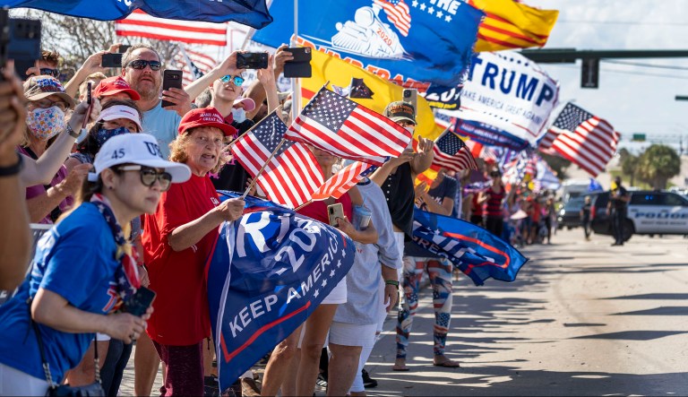 Supporters wait for former President Donald Trump to go by in West Palm Beach, Fla., Monday, Feb. 15, 2021. People lined the street on President's Day to show support for Trump who lost the 2020 election to President Joe Biden. 