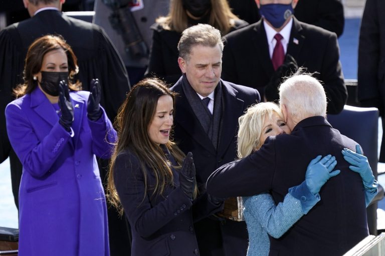 President Joe Biden hugs first lady Jill Biden, as his son Hunter Biden and daughter Ashley Biden.
