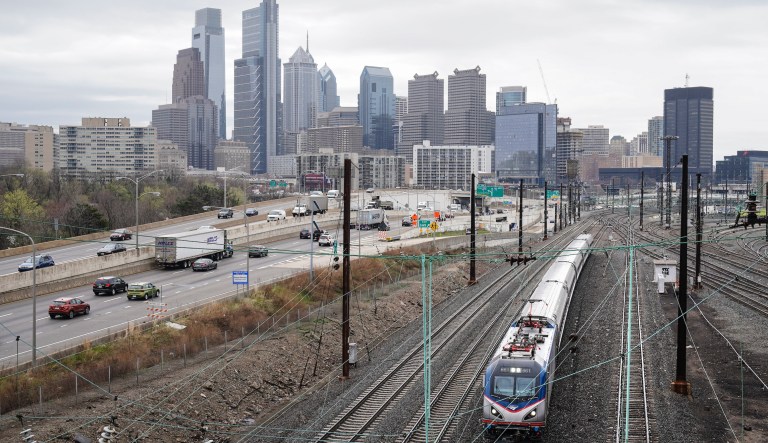 An Amtrak train departs 30th Street Station moving parallel to motor vehicle traffic on Interstate 76 in Philadelphia, Wednesday, March 31, 2021. Looking beyond the $1.9 trillion COVID relief bill, President Joe Biden and lawmakers are laying the groundwork for another of his top legislative priorities â a long-sought boost to the nation's roads, bridges and other infrastructure that could meet GOP resistance to a hefty price tag.
