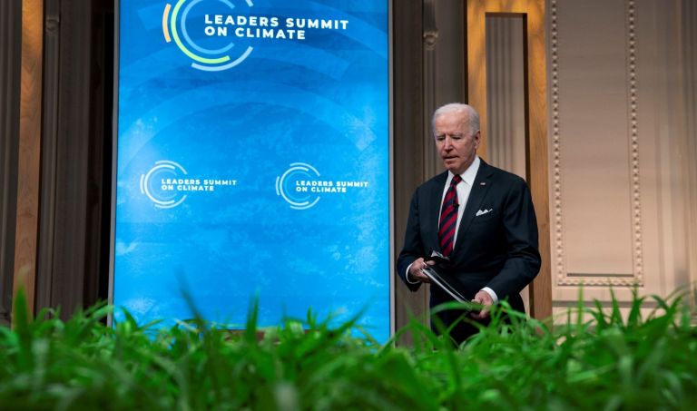 President Joe Biden takes his seat during the virtual Leaders Summit on Climate, from the East Room of the White House, Thursday, April 22, 2021, in Washington.