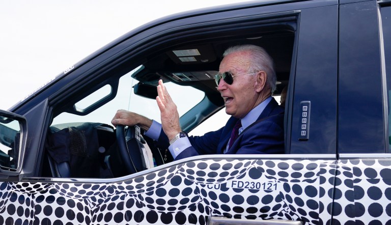 President Joe Biden stops to talk to the media as he drives a Ford F-150 Lightning truck at Ford Dearborn Development Center on Tuesday, May 18, 2021, in Dearborn, Michigan.